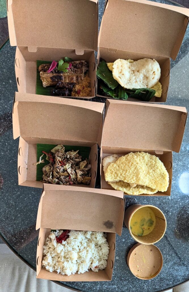 John Hardy Seminyak long table left-overs packaged with bamboo leaf and paper containers.