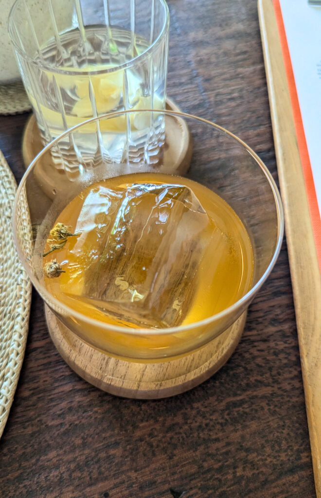 Beras kencur, jamu served on ice during a John Hardy long table meal.