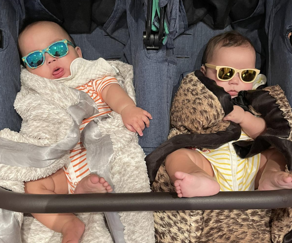 Yunta and Soh, Ei Arakawa-Nash's twin babies born from IVF, wearing mirrored sunglasses while sitting in their stroller.